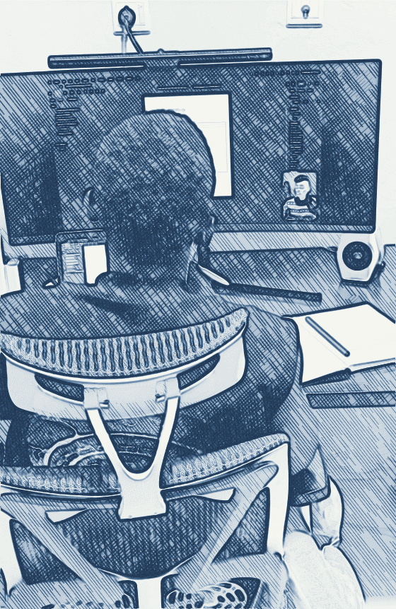 Shegz at a desk, working on a design on a large monitor